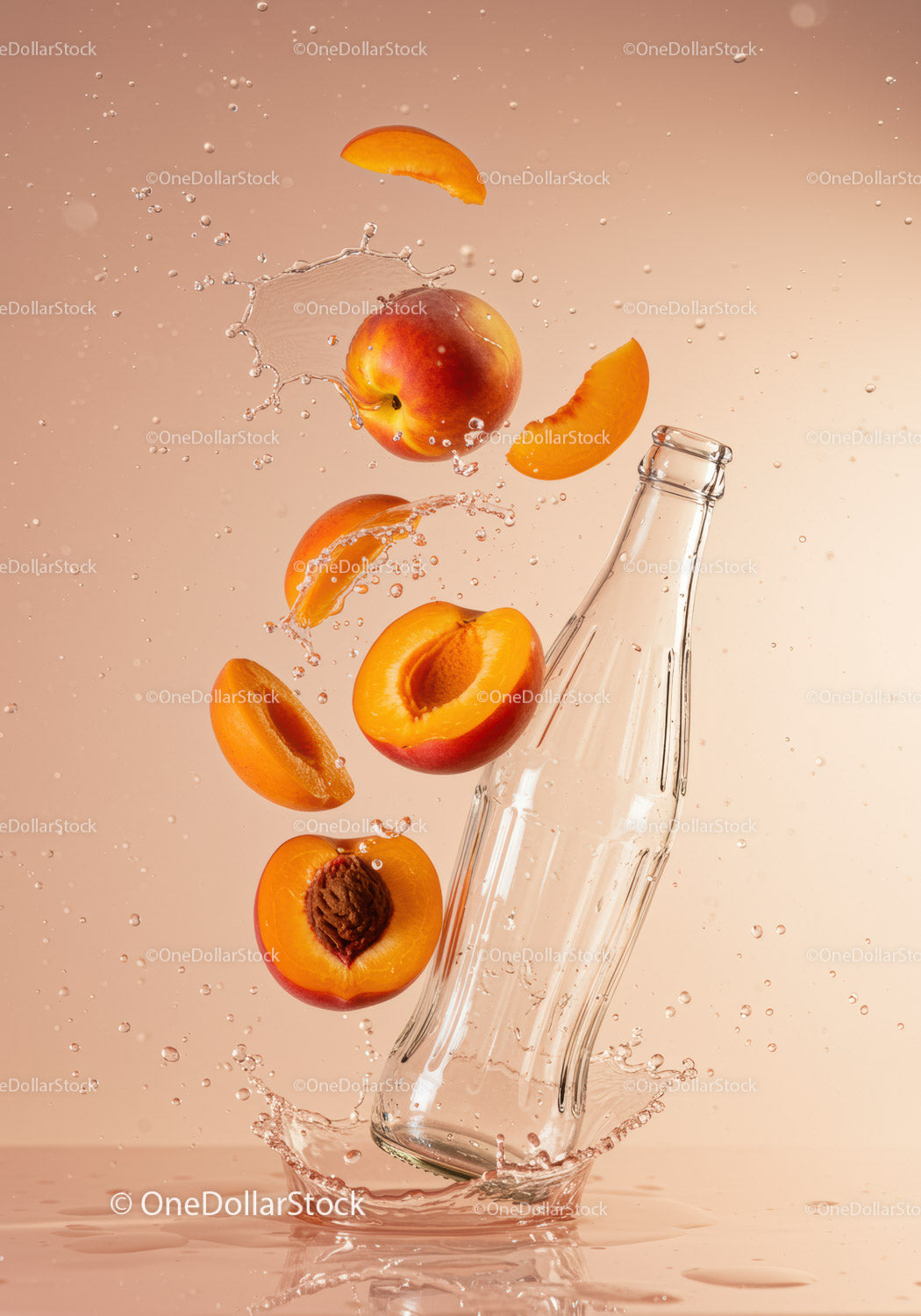 Fresh peaches splashing around a glass bottle