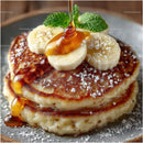 Close-Up of Fluffy Pancakes with Banana Slices and Maple Syrup