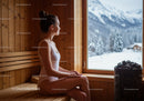 Young Woman Relaxing in Wooden Sauna with Snowy Mountain View