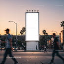 Urban crosswalk with illuminated blank billboard at sunset