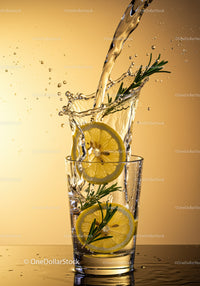 Refreshing water splash with lemon and rosemary in glass