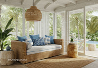 Cozy rattan sofa with blue cushions in sunlit room