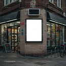 Urban corner store with illuminated blank billboard at dusk
