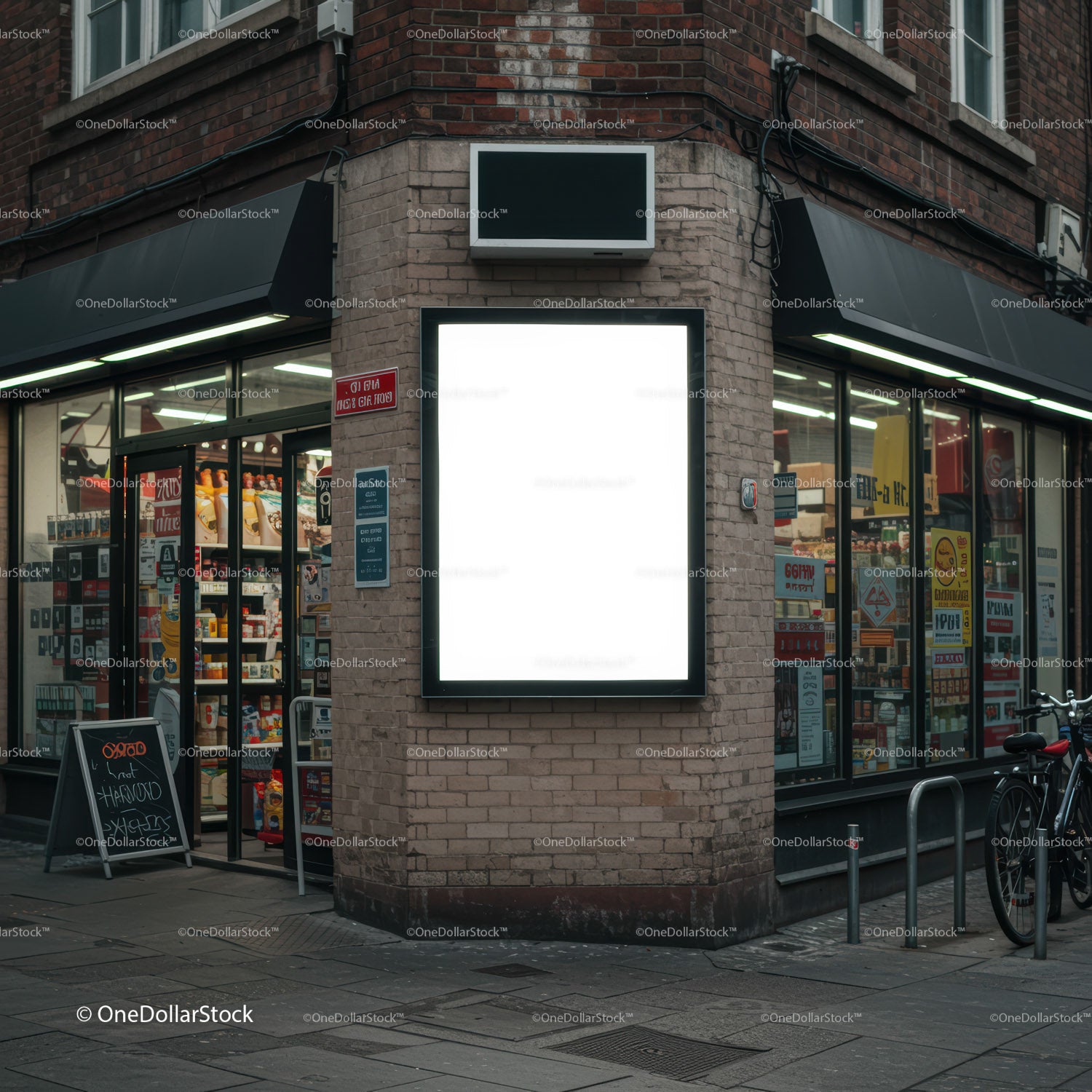 Urban corner store with illuminated blank billboard at dusk