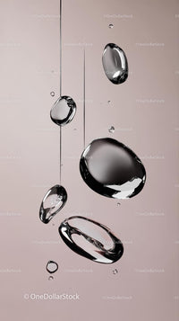 Close-up of Water Droplets Falling Against Soft Pink Background