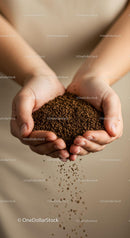 Close up of hands holding brown coffee granules