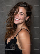 Smiling Young Woman with Wavy Hair in Black Lace Top Stock Photo