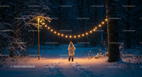 Child standing beneath warm string lights in snowy forest