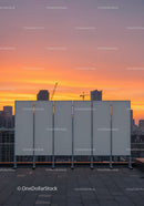 Modern City Skyline with Sunset Sky and Construction Cranes
