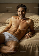 Smiling man relaxing on bed in white underwear
