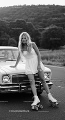 Young woman on roller skates leaning on vintage car