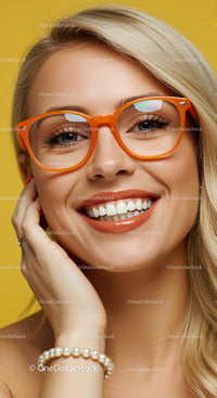 Smiling woman with orange glasses and pearl bracelet