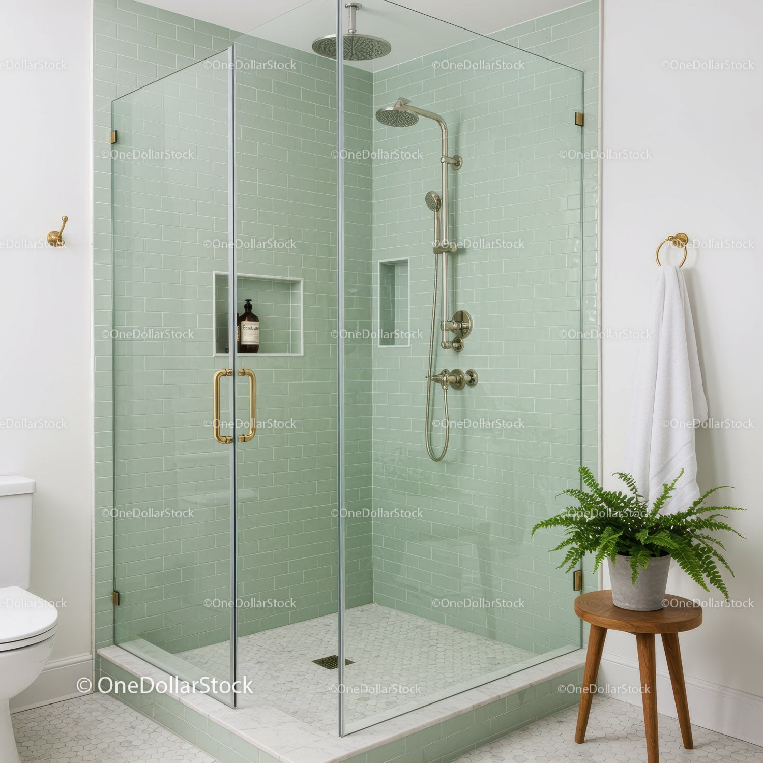 Modern glass shower with soft green subway tiles