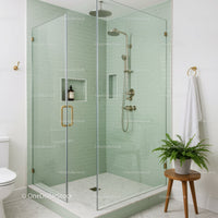 Modern glass shower with soft green subway tiles