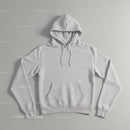 Minimalistic white hoodie laid flat on neutral background