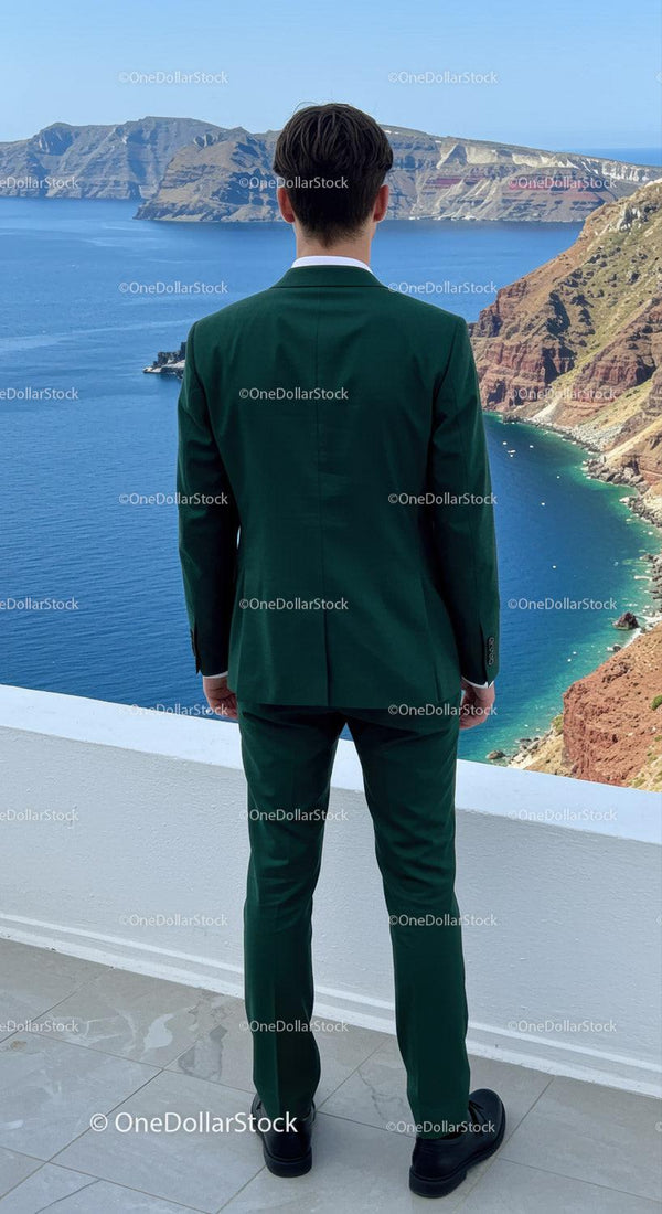 Man in Green Suit Gazing at Scenic Coastal Cliffs