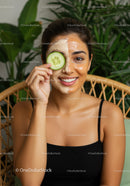 Young Woman with Facial Mask and Cucumber Slice for Skincare Relaxation