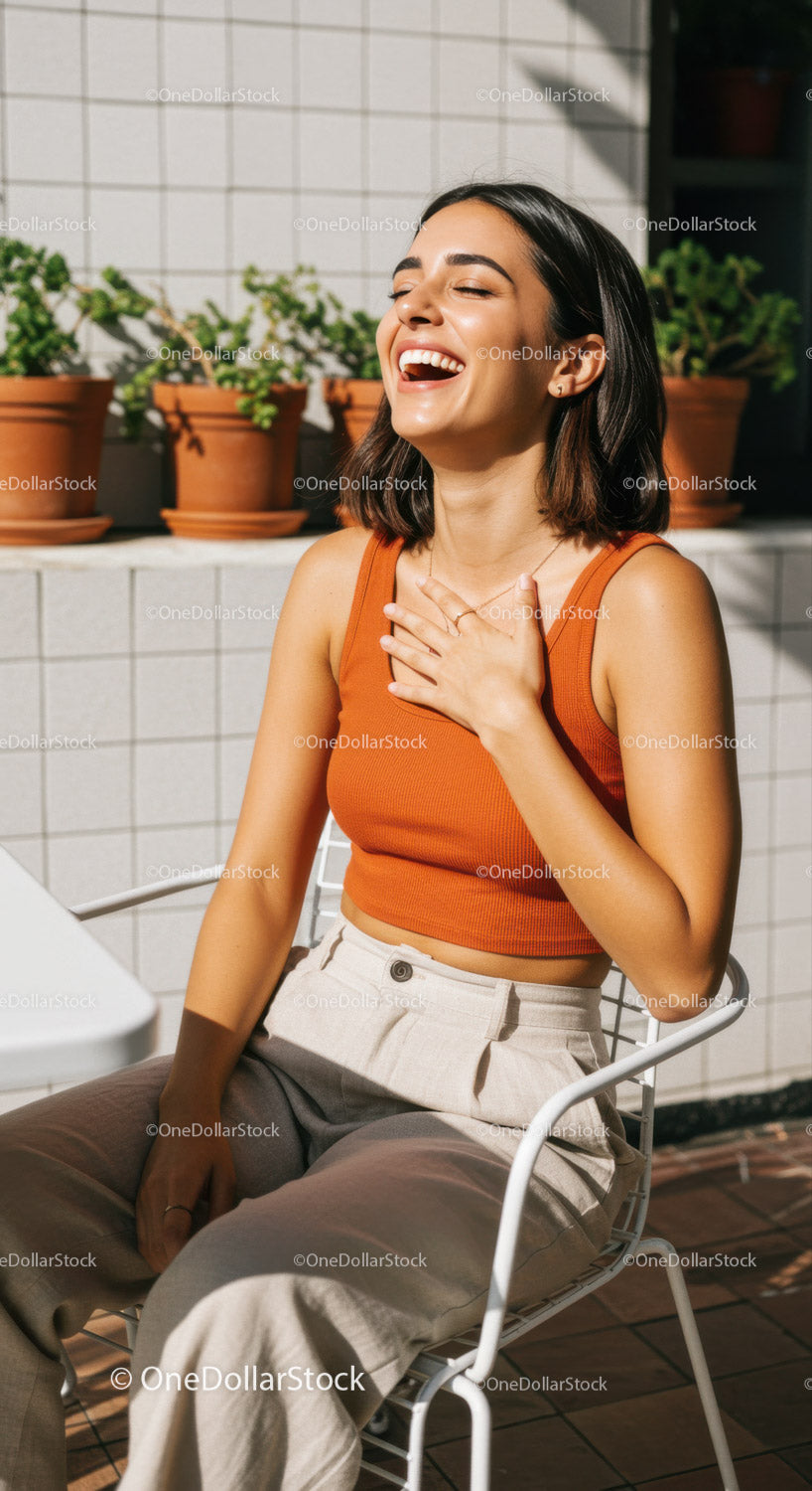 Joyful Woman Laughing Outdoors on Patio in Summer Fashion