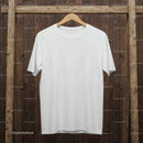 Plain white t-shirt hanging on rustic wooden background