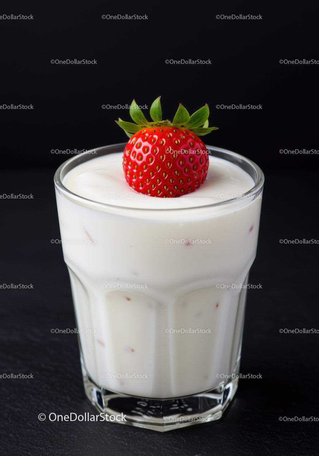 Fresh strawberry topping creamy yogurt in clear glass