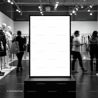 Blank advertising board in modern fashion store interior