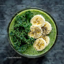 Fresh Green Smoothie with Banana Slices and Kale Leaves