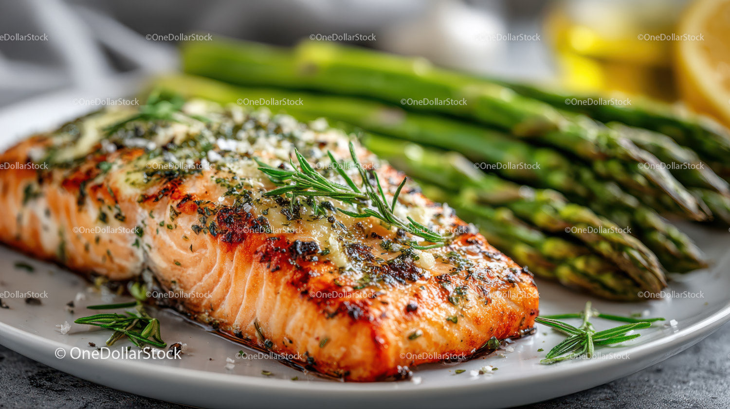 Herb Garnished Salmon Fillet with Grilled Asparagus and Lemon Slices