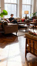 Man reading book in bright cozy living room