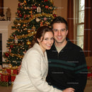 Smiling couple embracing near decorated Christmas tree