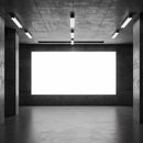 Empty industrial space with large illuminated display panel