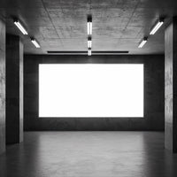 Empty industrial space with large illuminated display panel