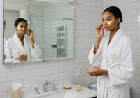Elegant Woman Applying Gold Eye Patches in Wellness Routine