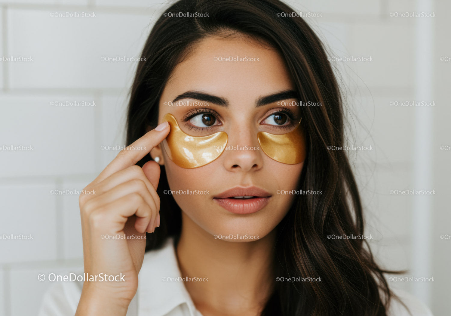 Young Woman Applying Gold Under Eye Patches for Skincare Routine