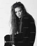 Black and White Portrait of a Woman with Intense Gaze and Wet Hair
