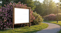 Wooden billboard surrounded by blooming pink flowers in park