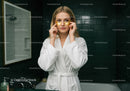 Young Woman Applying Under Eye Patches in Bathroom Spa Setting