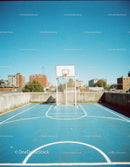 Urban Rooftop Basketball Court with City Skyline and Bright Sky