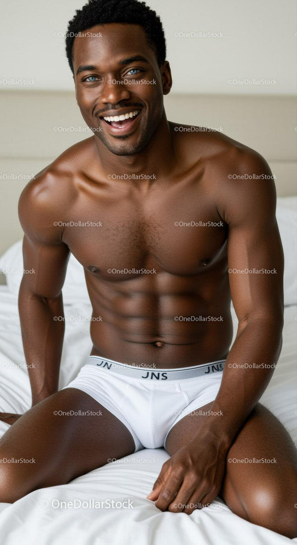 Smiling muscular man sitting on bed in white underwear