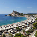 Beautiful Mediterranean Beach with White Umbrellas and Fortress Vista