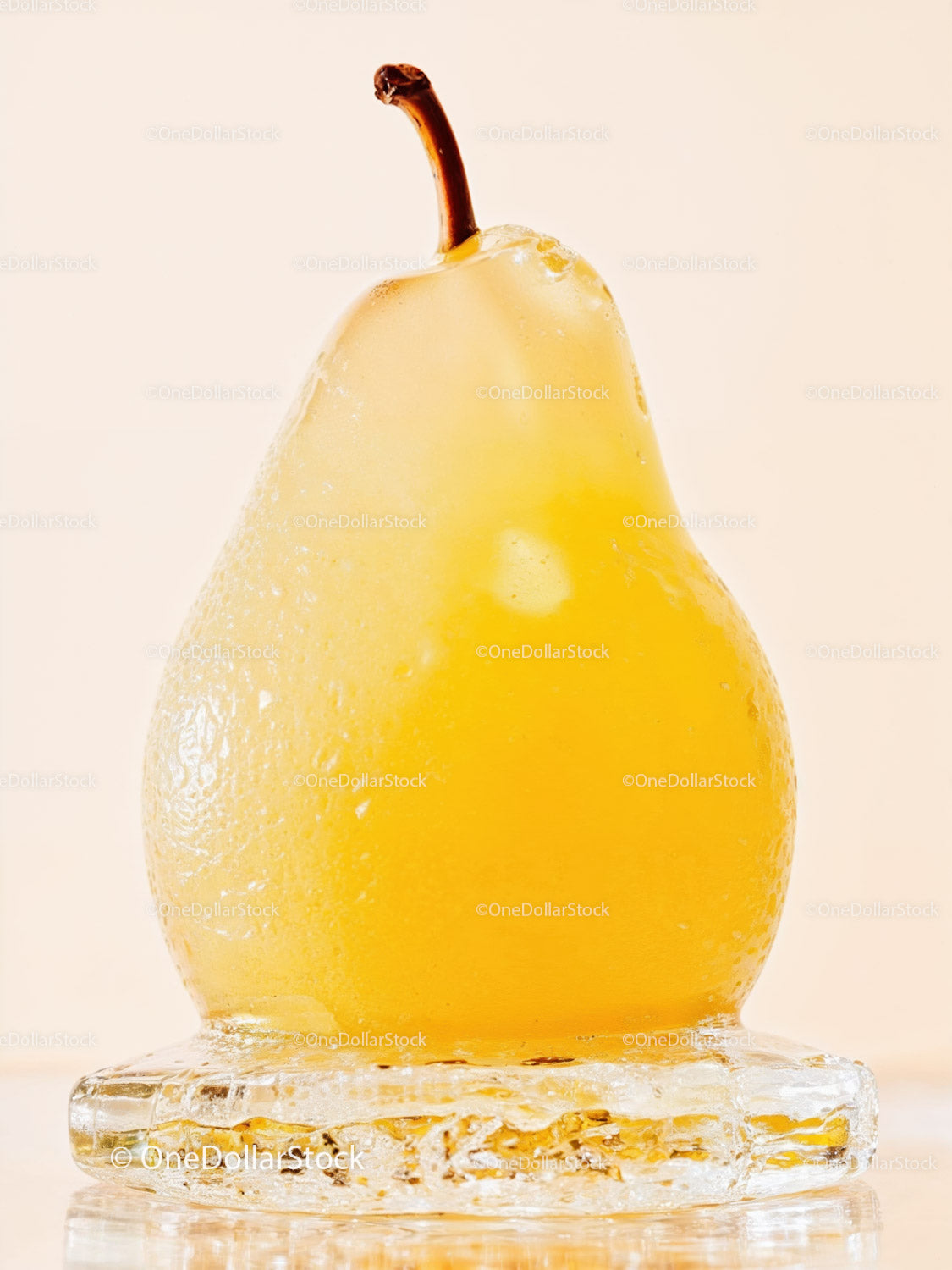 Fresh yellow pear encased in melting ice cube
