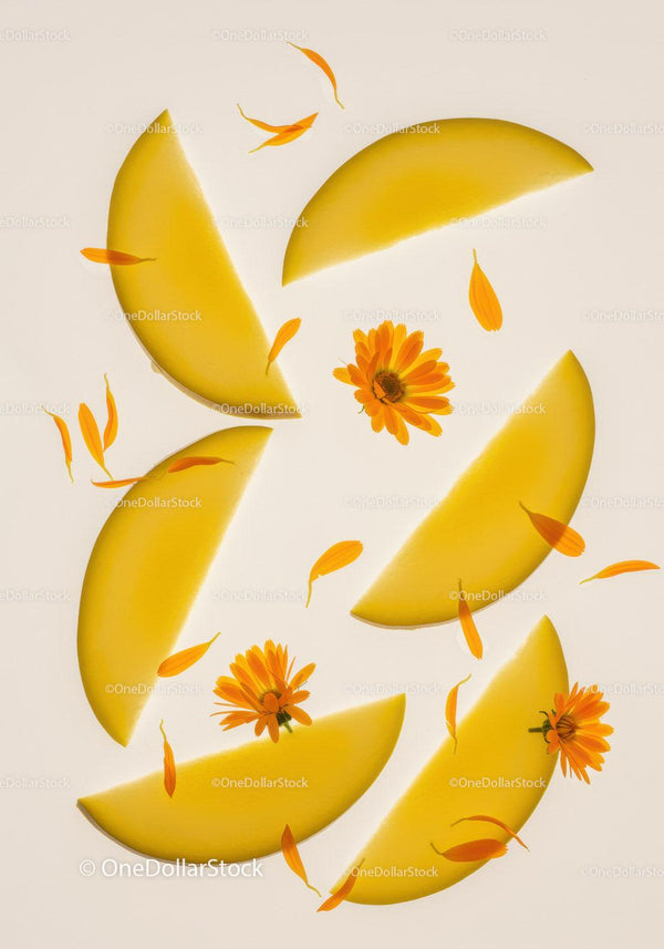 Fresh Yellow Mango Slices with Marigold Flowers