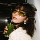 Chic Woman with Yellow Sunglasses and Refreshing Green Drink