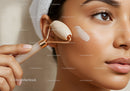 Close-Up of Young Woman Using Jade Facial Roller for Skincare