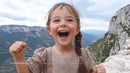 Happy Girl Celebrating Outdoors in Scenic Mountain Landscape