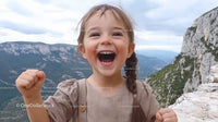 Happy Girl Celebrating Outdoors in Scenic Mountain Landscape