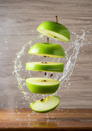 Fresh green apple sliced with dynamic water splash