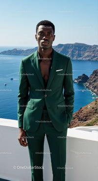 Elegant man in green suit standing by ocean cliff