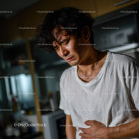 Young Man Experiencing Abdominal Pain and Discomfort