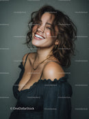 Joyful Woman With Curly Hair Smiling in Studio Portrait
