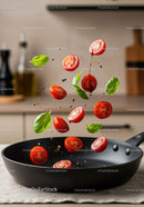 Fresh cherry tomatoes and basil leaves tossed in skillet